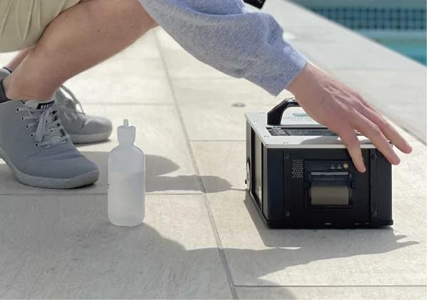 man-using-tribometer-next-to-pool